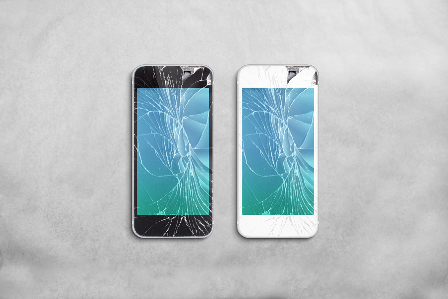 Two iPhones with cracked screens. One phone is white and one phone is black.